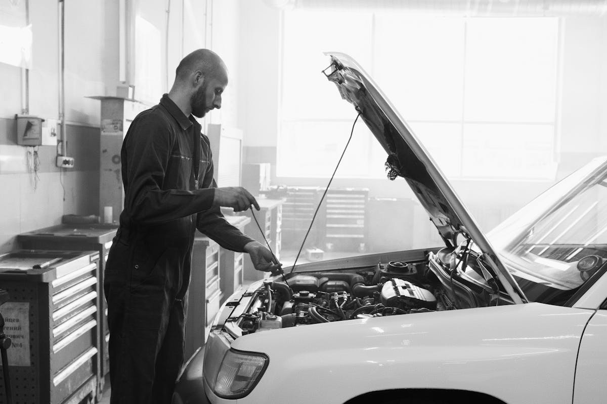 A technician carrying out an MOT inspection on a car