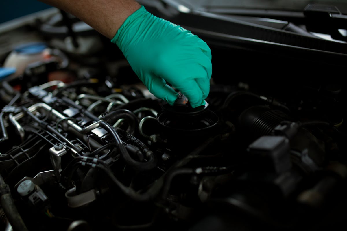 A mechanic checking the oil during a car service
