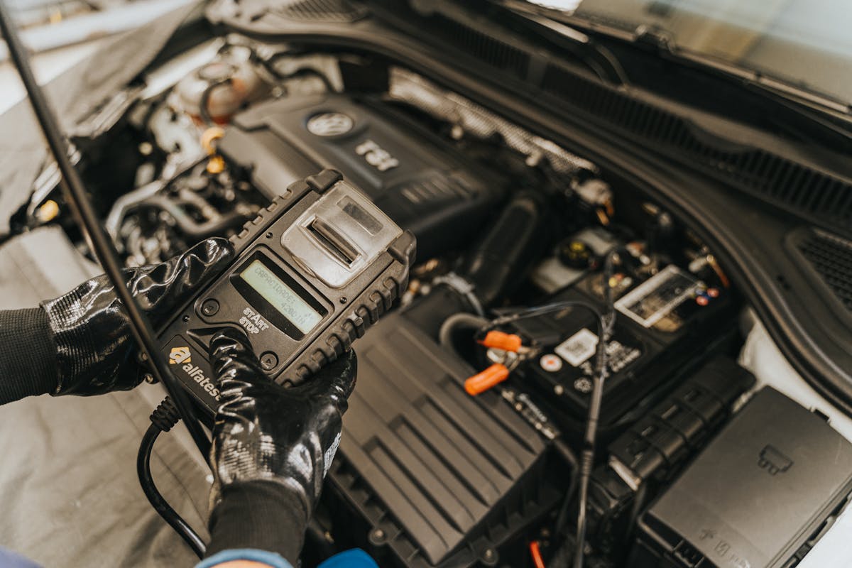 A technician working on a performance car engine